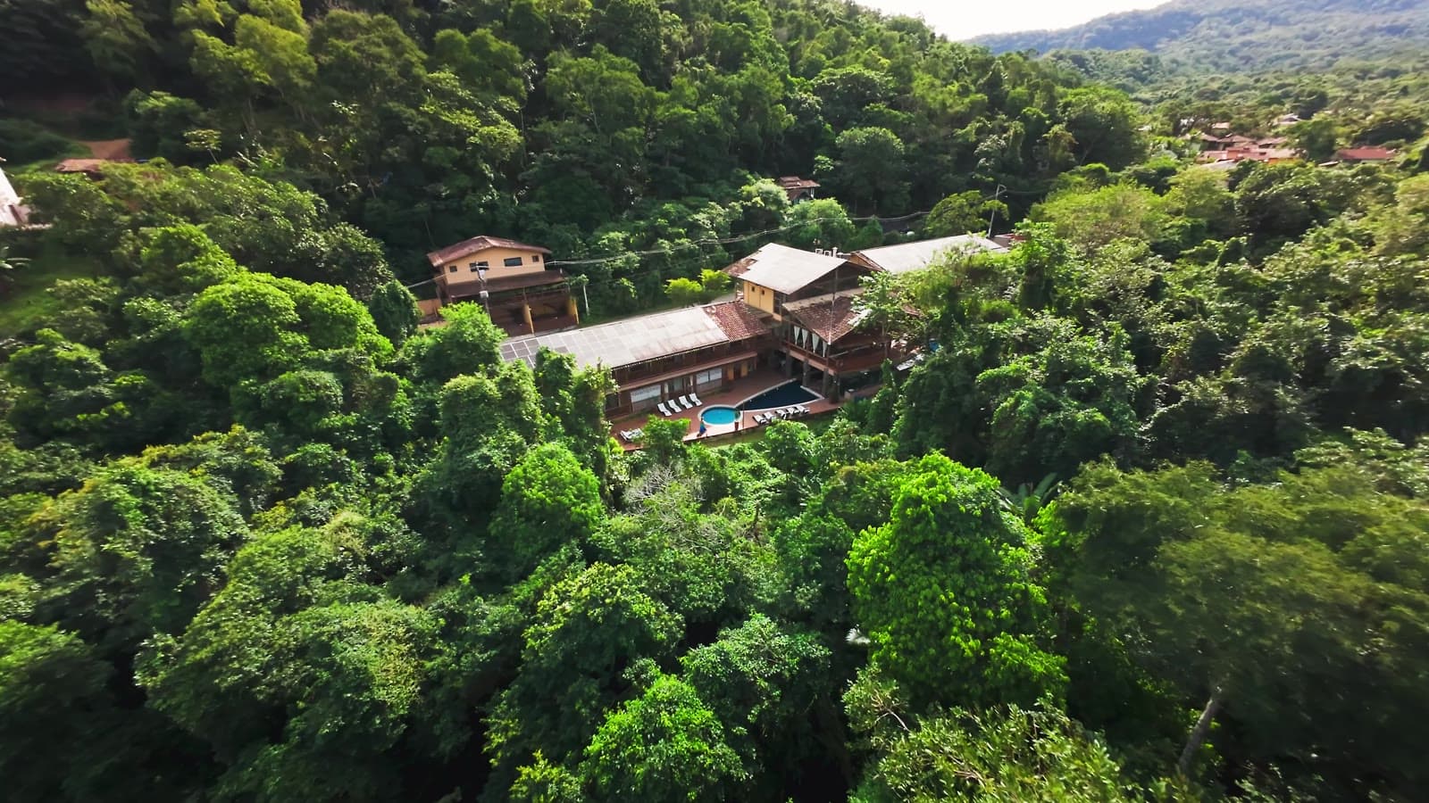 Frame from the Kalango film: the hotel seen from the air, set into Atlantic forest.